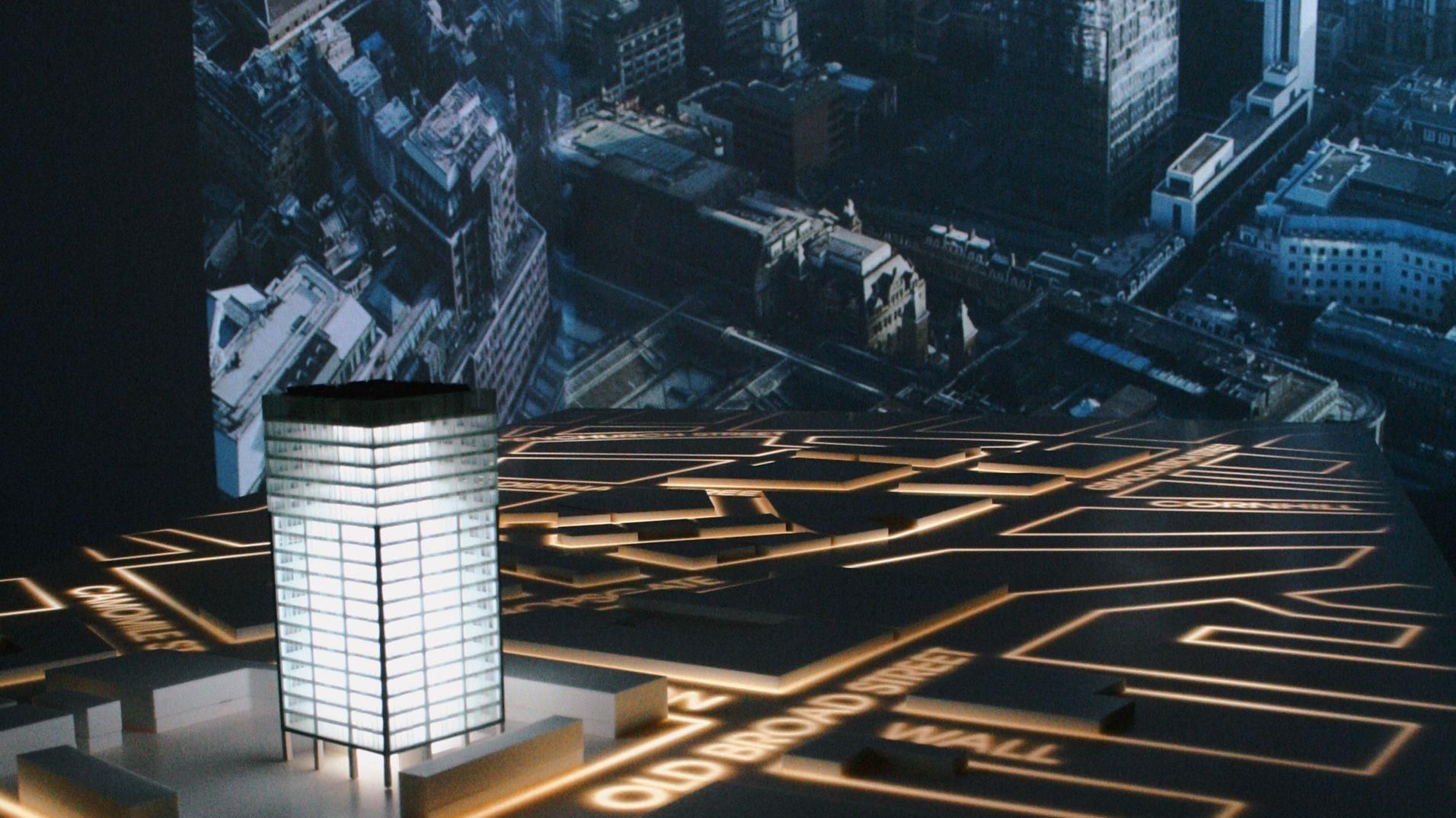 A close view of the illuminated street map projected across the meeting table.