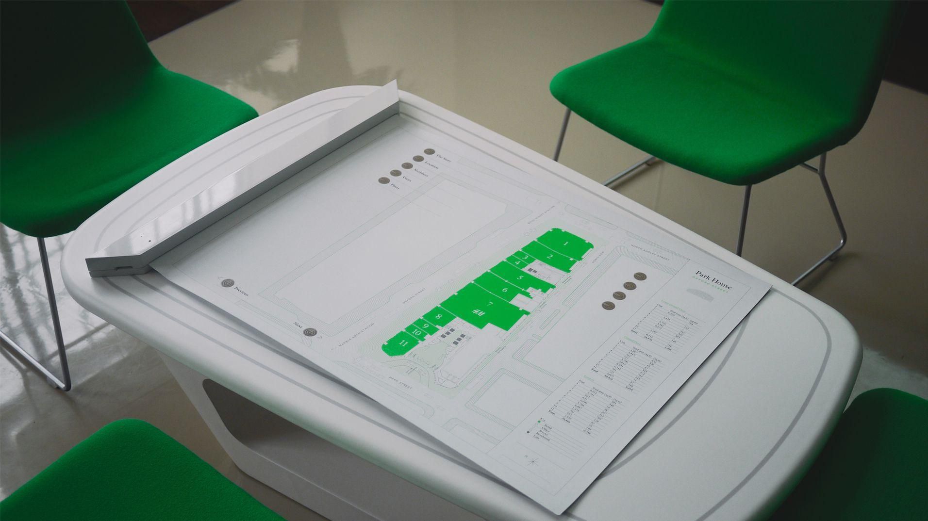 The printed architectural plan used as an interactive control surface.