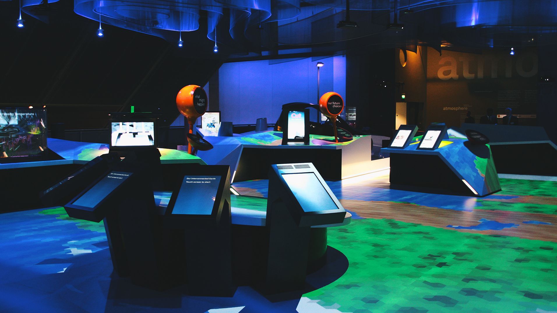 The central Atmosphere installation glowing blue and green inside the Science Museum gallery.