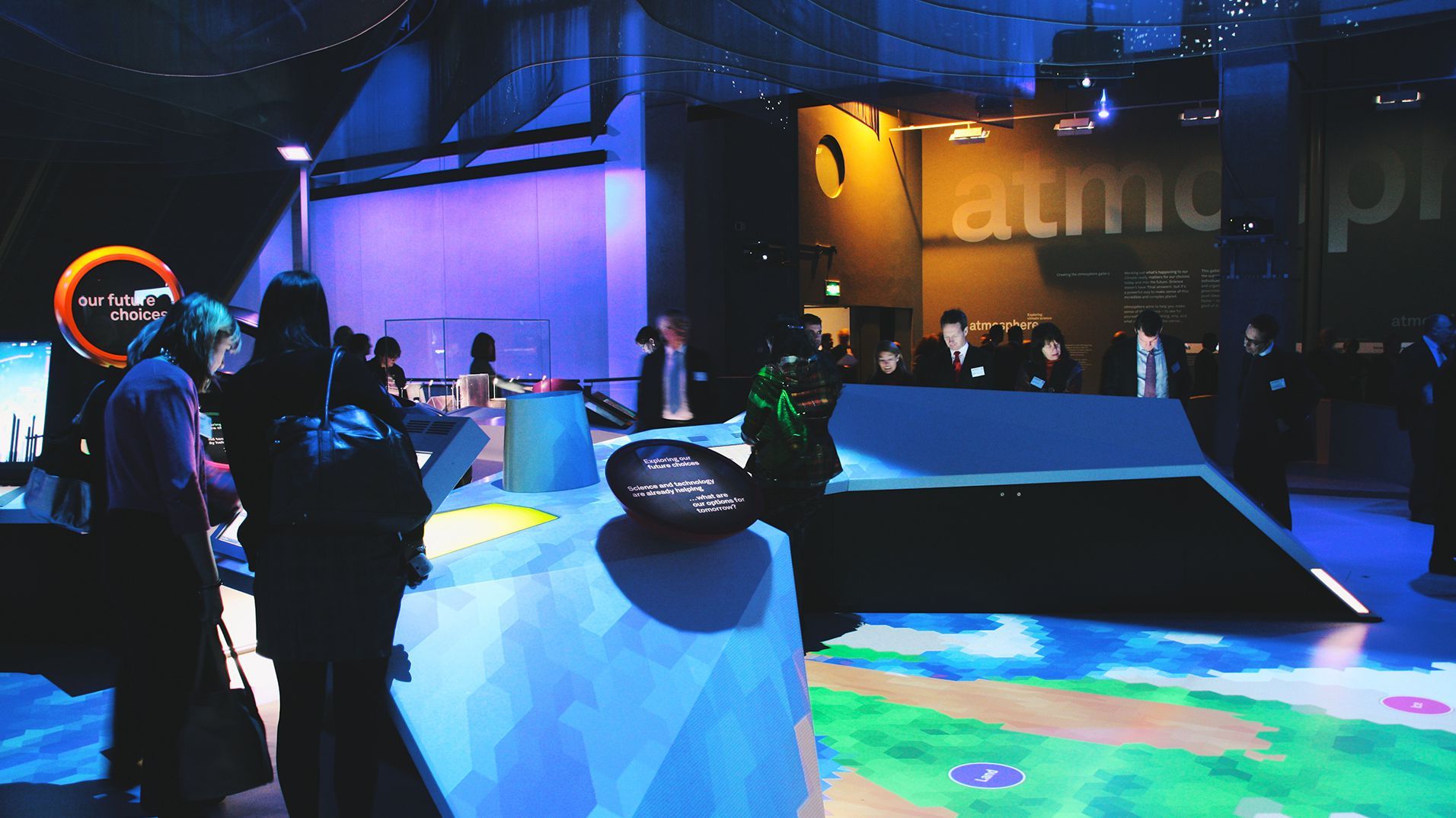 Visitors gathered around the angular interactive exhibits in the Atmosphere gallery.