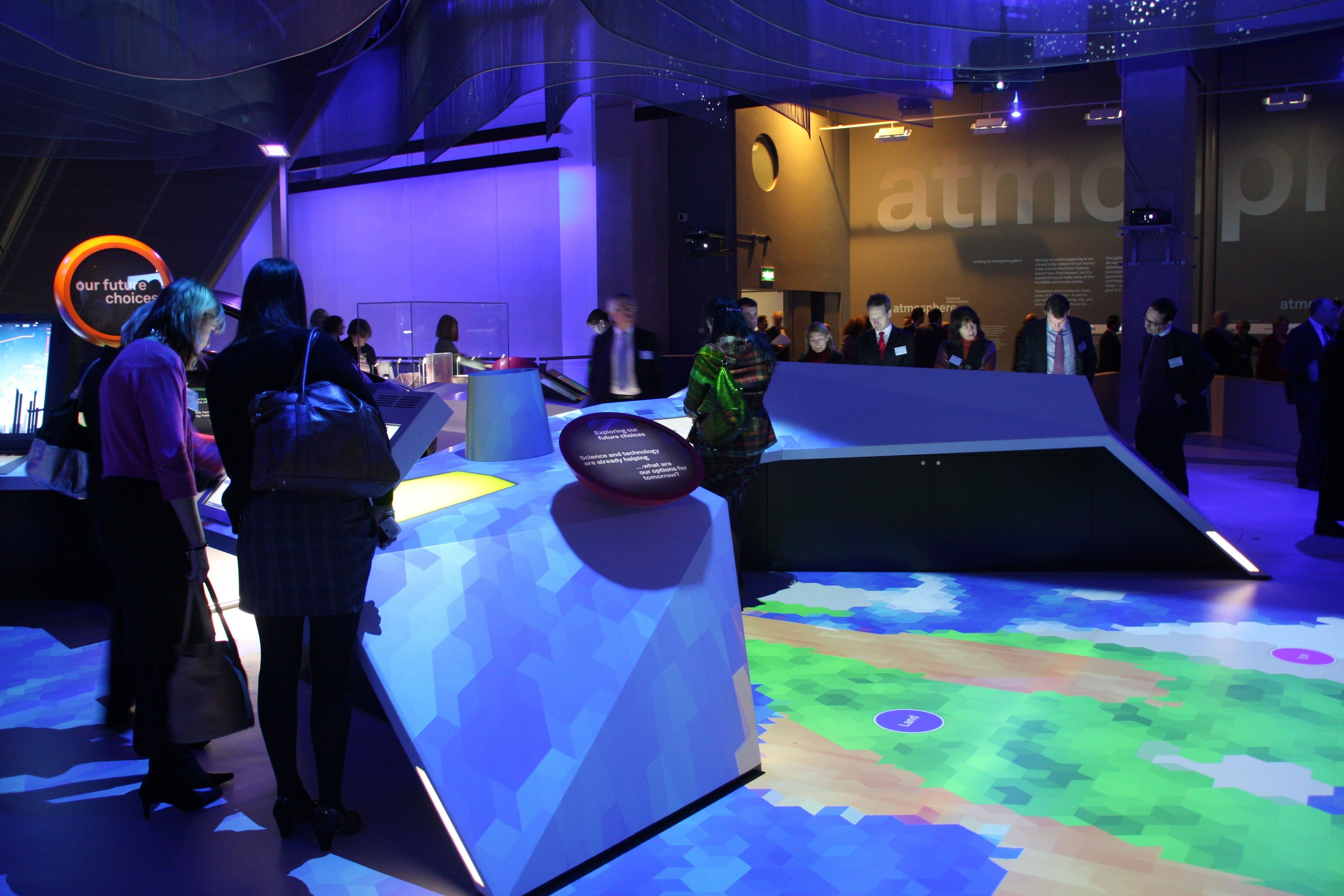 Visitors gathered around the faceted central multiplayer kiosks.