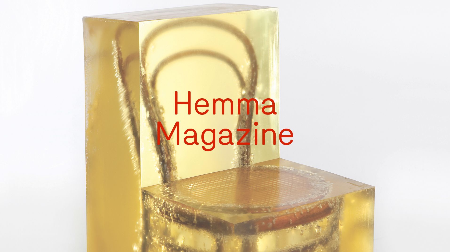 Hemma Magazine branding applied to a translucent gold chair.